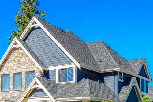 Stone and gray siding on home with gray roof